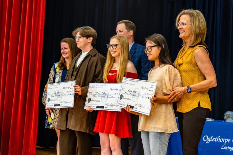 Oglethorpe County High School seniors (from left) Clay Reece, Kamryn King and Spee Paw received the Douglas P. Griffin Memorial scholarship from members of the Griffin family. (Photo/Jack Casey)