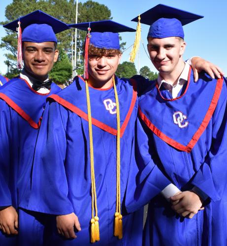 Bryan Valladares (left to right), Logan Turner and Chayton Tuck smile as they prepare to walk to their seats for the graduation ceremony. (Photo/Sarah Evans)