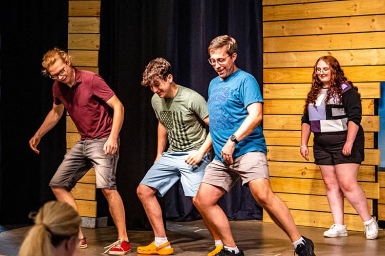 “Big Fish” cast members (from left) Karl Jaeger, Micah Trump (Young Will), Drew Doss (Edward Bloom) and Lydia Todd (Alabama Lamb) practice a dance routine during rehearsal for production. (Photo/Jack Casey)