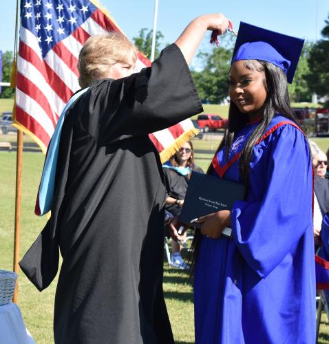 Maci Mitchell smiles with her diploma as Oglethorpe County School System Superintendent Beverley Levine turns her tassel. (Photo/Sarah Evans)