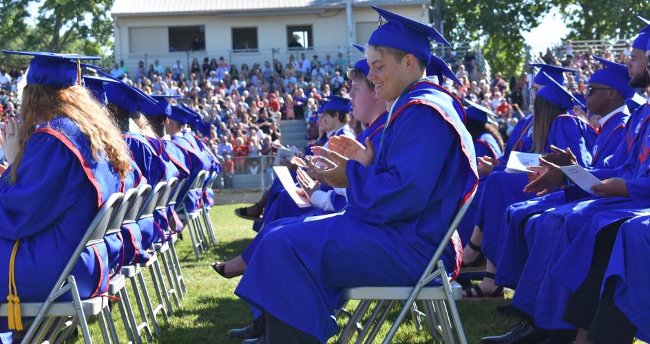 Dominic Goldt claps after OCHS Principal Susie Johnson’s welcome speech at the graduation ceremony on May 28. (Photo/Sarah Evans) 