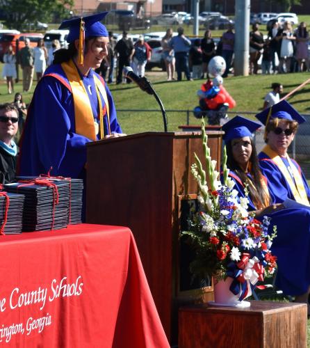 OCHS valedictorian Elizabeth Palmer delivers her graduation speech, titled “Never Gonna Turn Around.” Palmer encouraged her peers to maintain a grateful attitude and strong work ethic. (Photo/Sarah Evans)