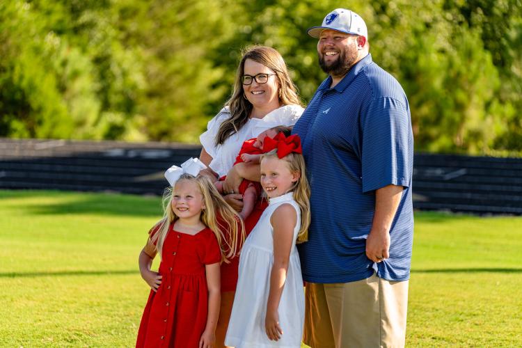 Assistant cheerleading coach Kasey Taylor with husband Levi Taylor and their children Stafford, Ellis and Cooper. (Photo/Jack Casey)