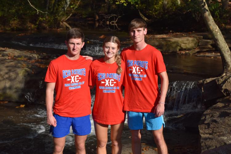 Kyle Frankel (from left), Lizzie Wadsworth and Luke McGarity at the Carrollton Greenbelt trail on Thursday before the state championship.