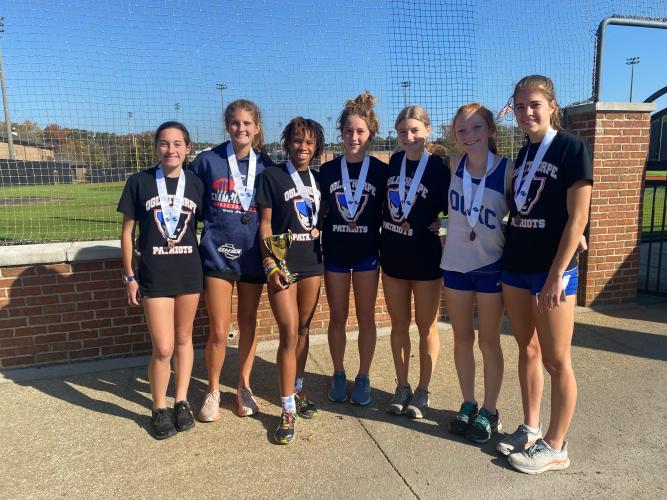 Harper Palmer (from left), Abby Cabaniss, Sydnie Henderson, Elin Turner, Lizzie Wadsworth, Mylee Nimmons and Emmaleigh Hemingway wear their medals after the state meet.