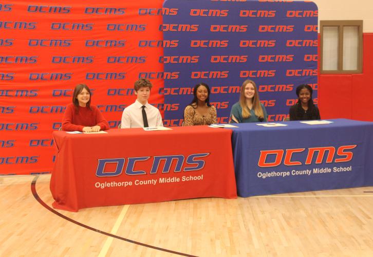 Oglethorpe County Middle School’s five REACH Scholars wait for the signing ceremony to begin. The five students are (from left): Emma Baker, Christian Harris, Mya Jewell, Melody Roberts and Shyanne Spade. They will receive $10,000 in scholarship funds and mentoring resources if they maintain good grades, attendance and behavior throughout high school. (Submitted Photo)