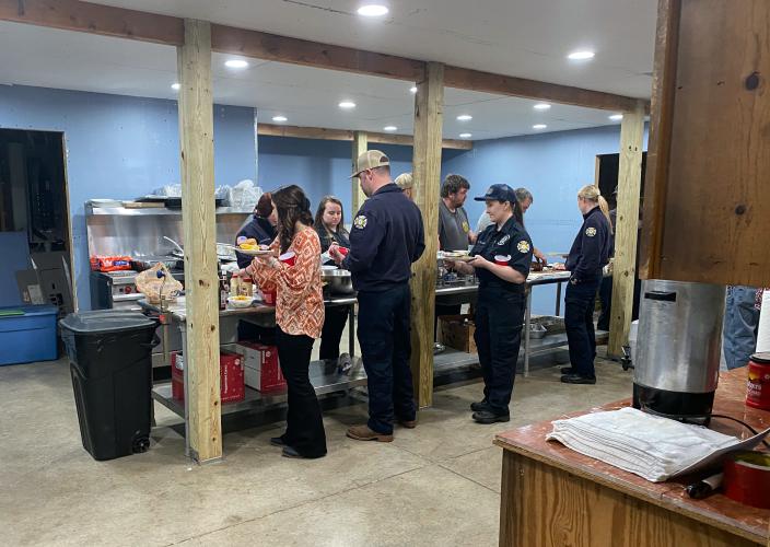 First-responders and guests form a line for their free dinner on Saturday. Some of the cooks are also first-responders. (Photo/Brooke Stewart)