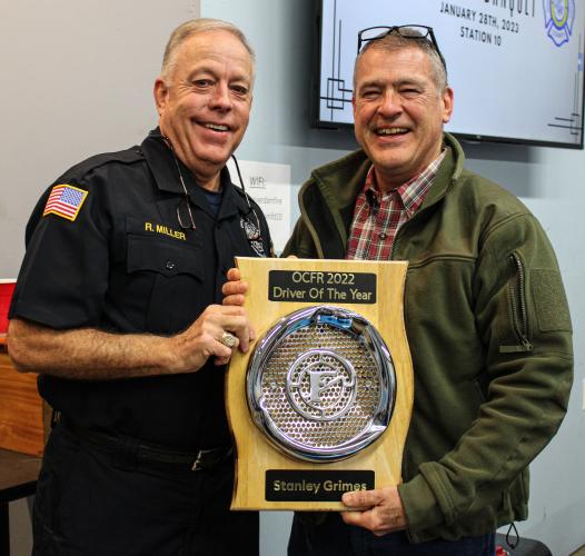 Chief Rocky Miller (left) gives the Driver of the Year award to assistant chief Stanley Grimes of Devil's Pond Station on Saturday. Laughs were shared amongst everyone as he damaged a fire truck. (Submitted photo/Cody Gibbs)