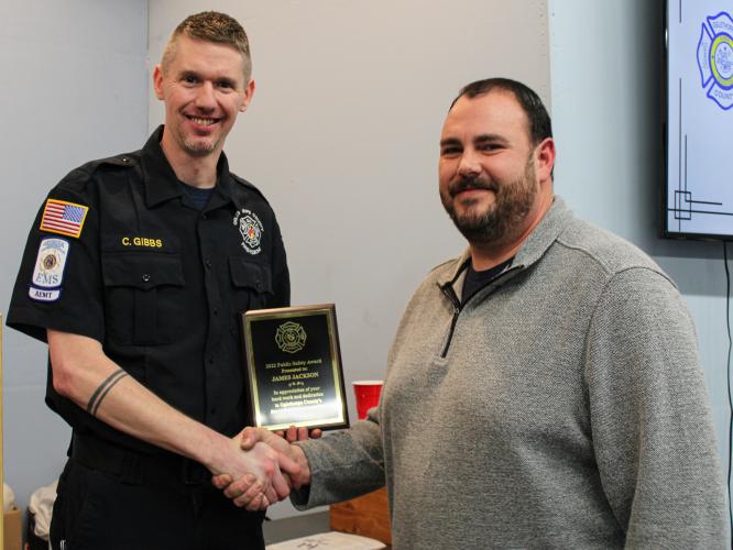 Assistant chief Cody Gibbs (left) gives the Public Safety Award to James Jackson on Saturday. Jackson serves as the E-911 director and county coroner. (Submitted photo/Cody Gibbs)