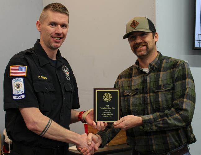 Assistant chief Cody Gibbs (left) gives a Firefighter of the Year award to Crawford assistant chief Ryan Martin at the Oglethorpe County Fire Rescue Banquet on Saturday. Martin also serves as a firefighter for Athens-Clarke County. (Submitted photo/Cody Gibbs)